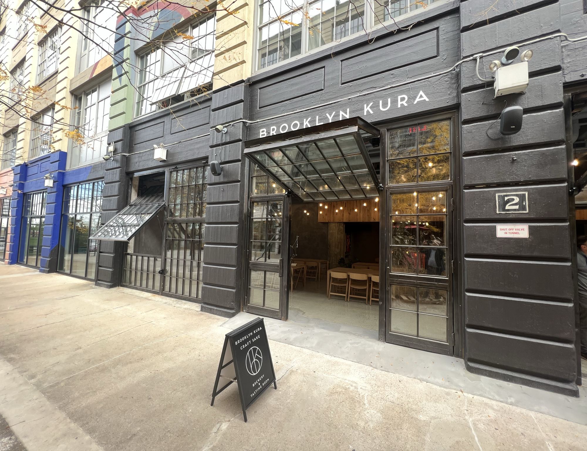 The Brooklyn Kura storefront with its taproom doors open at Industry City