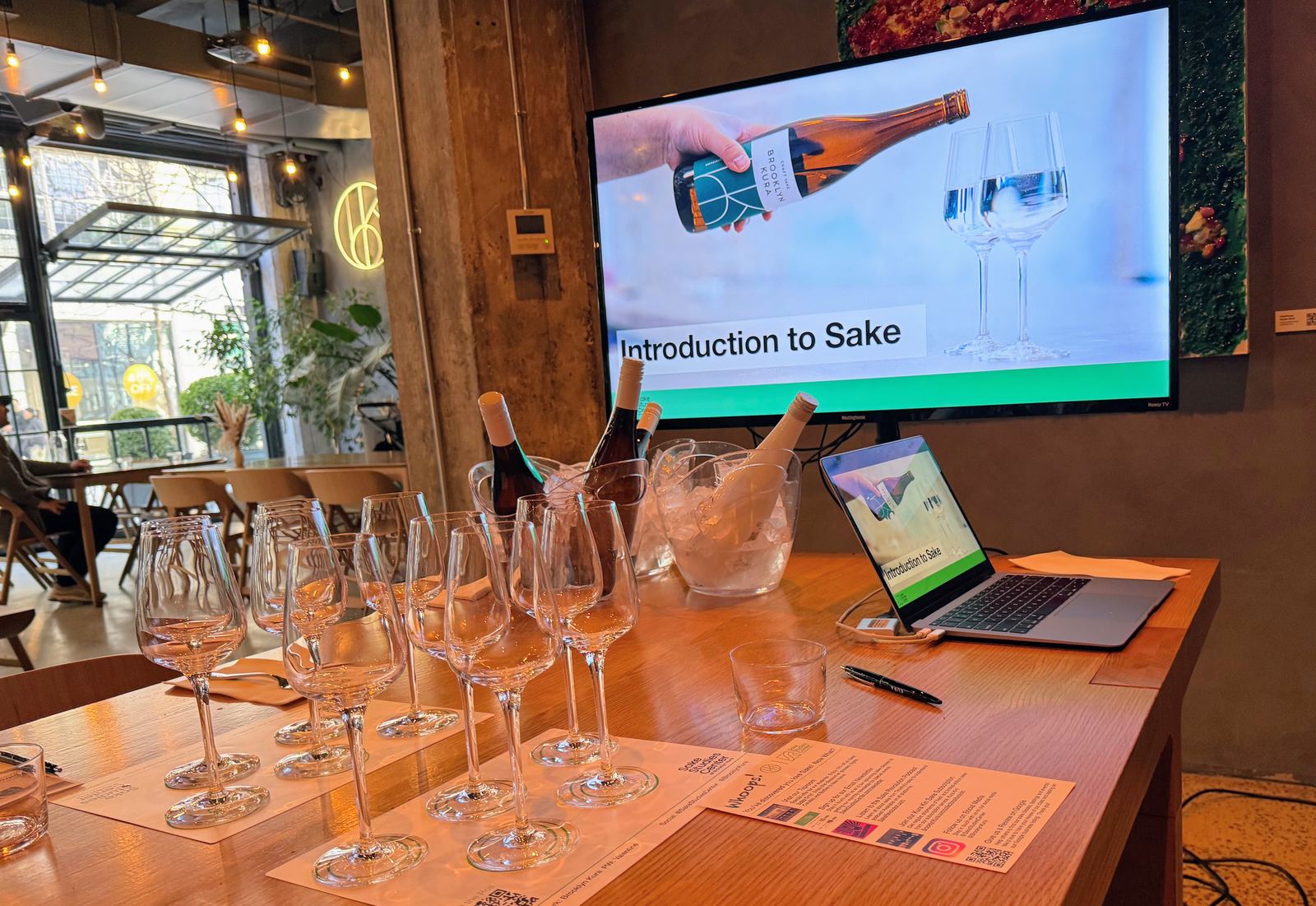 The tasting table set for an Introduction to Sake class, glasses and bottles ready