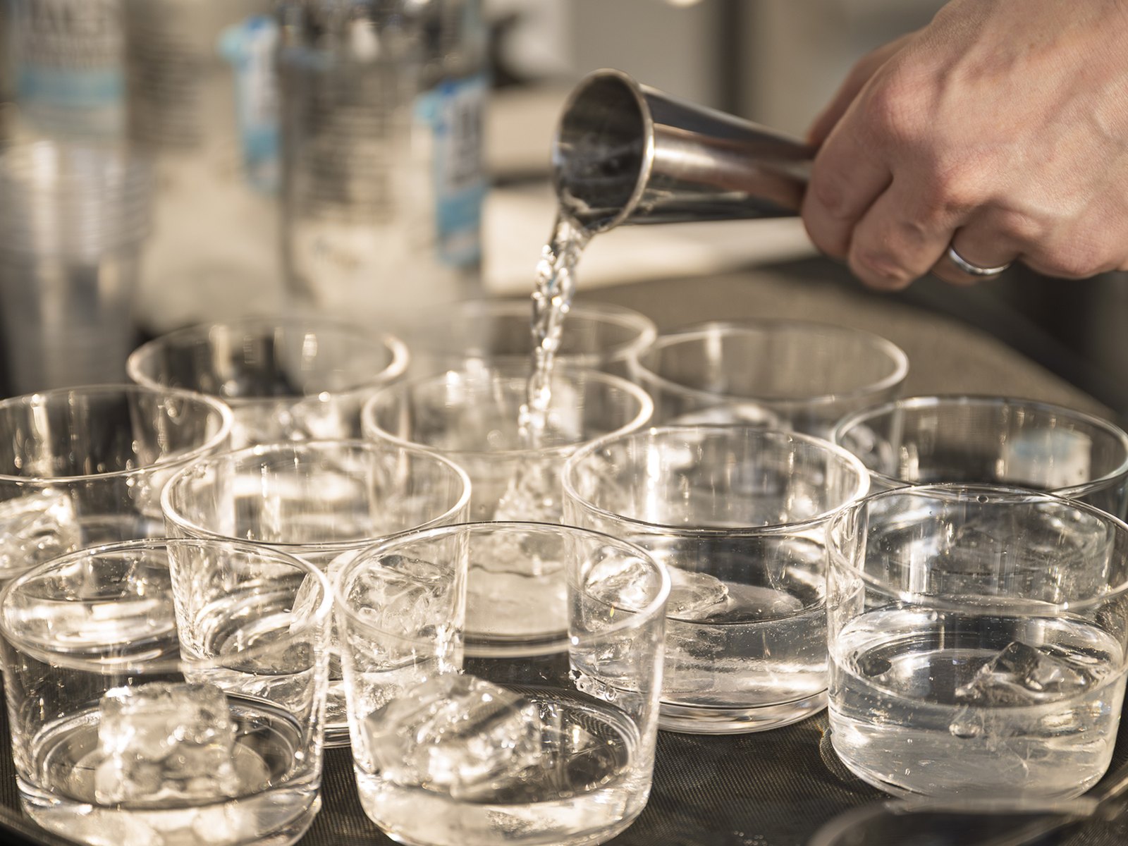 Shochu being poured over ice into rocks glasses