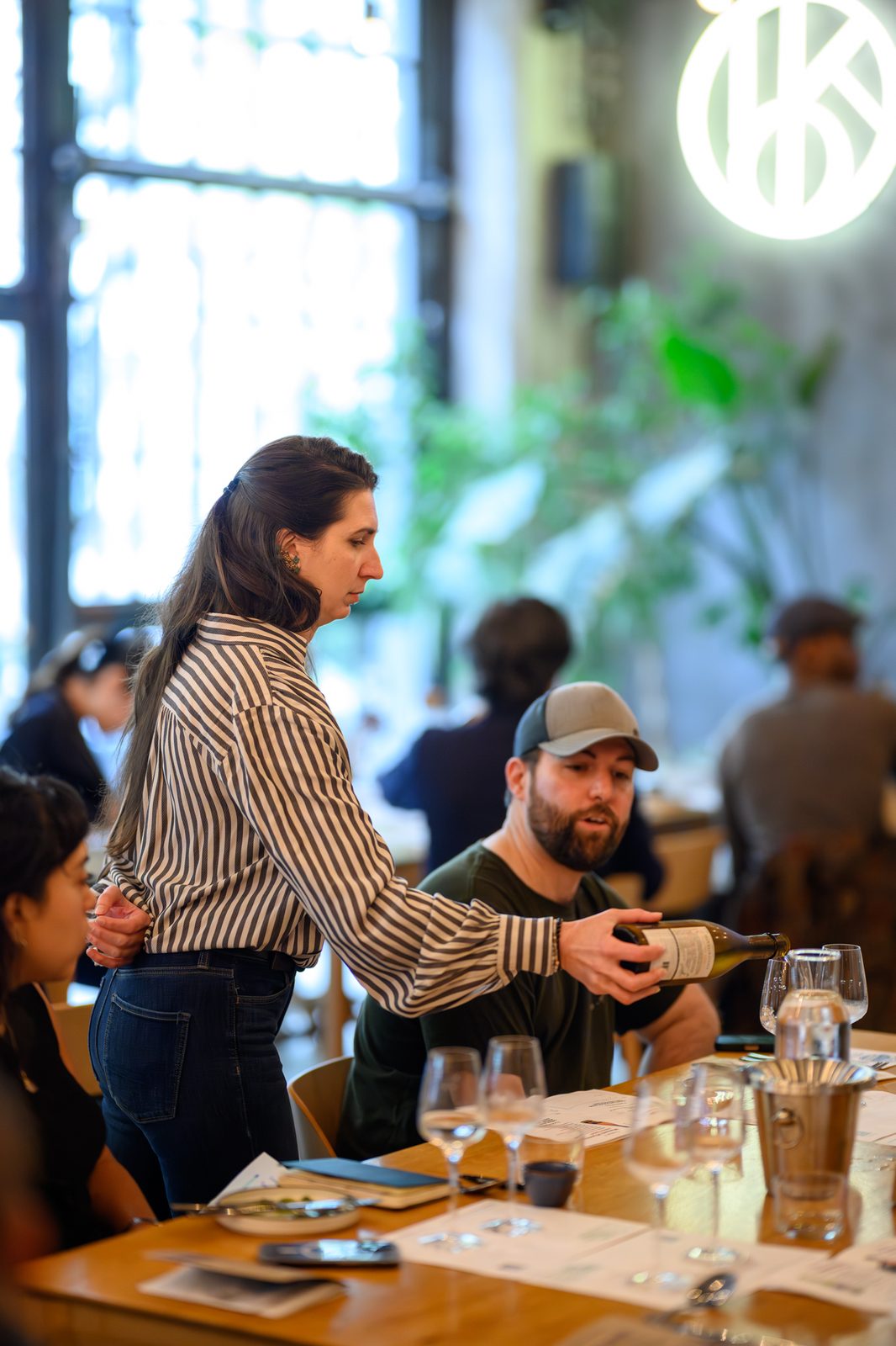 A server pours sake for guests at a previous Sake for Wine Somms luncheon